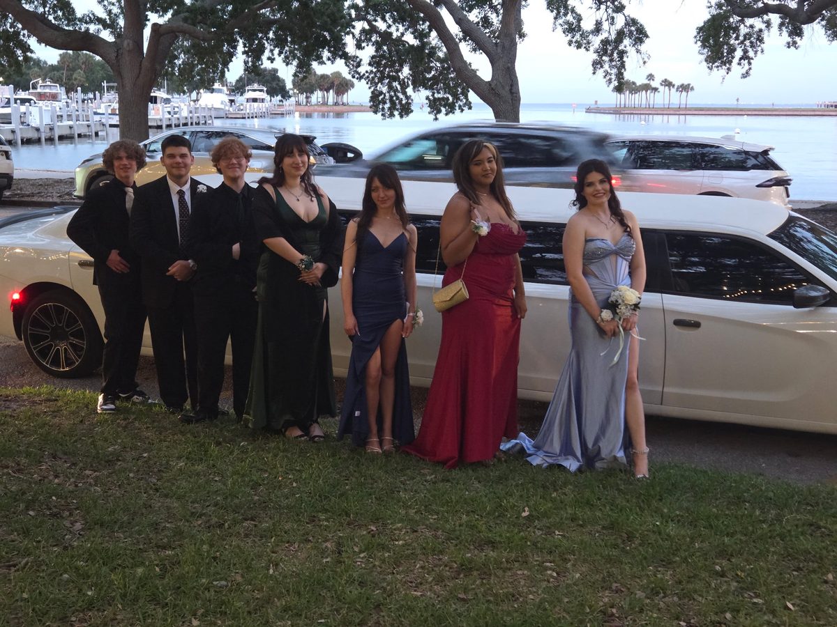 Crew in formalwear by the white stretch limo at the Tampa Bay waterfront
