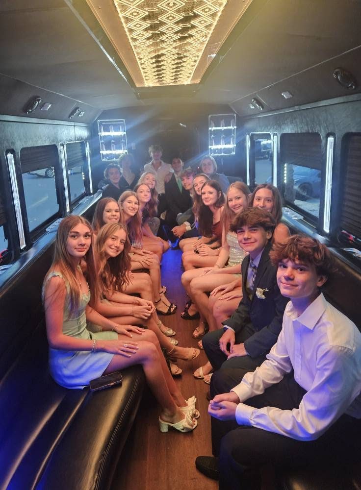 Group with bouquets by the white limo