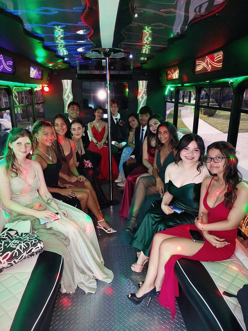 Students inside a lit-up Big Time Limo party bus